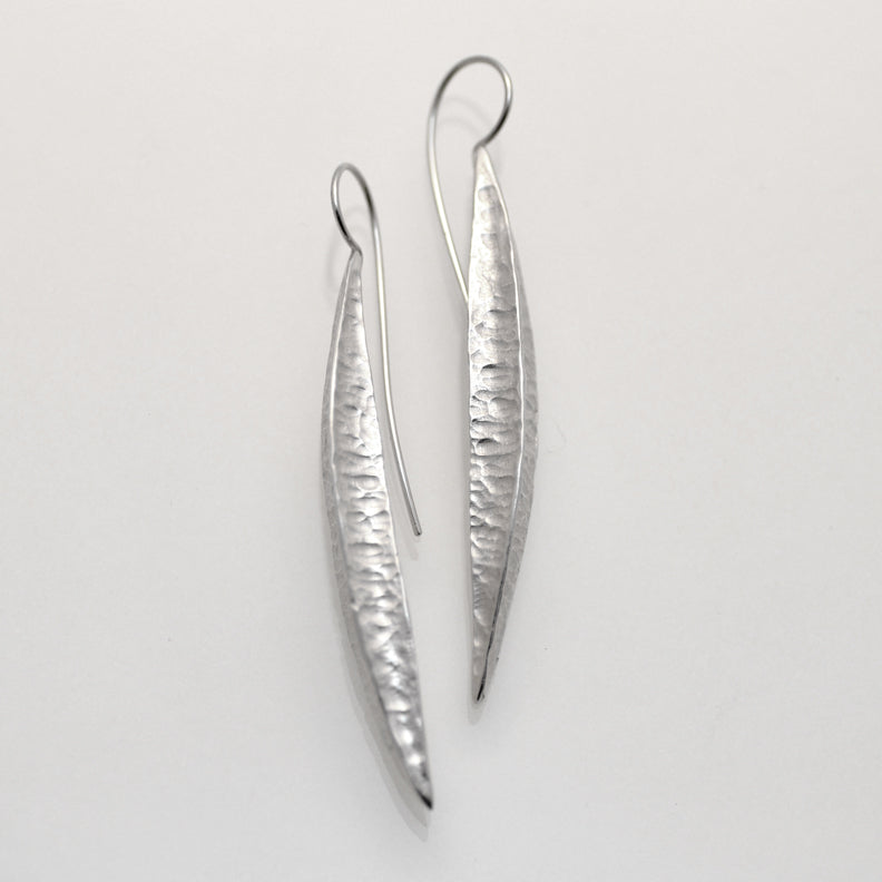 Long silver textured pod earrings