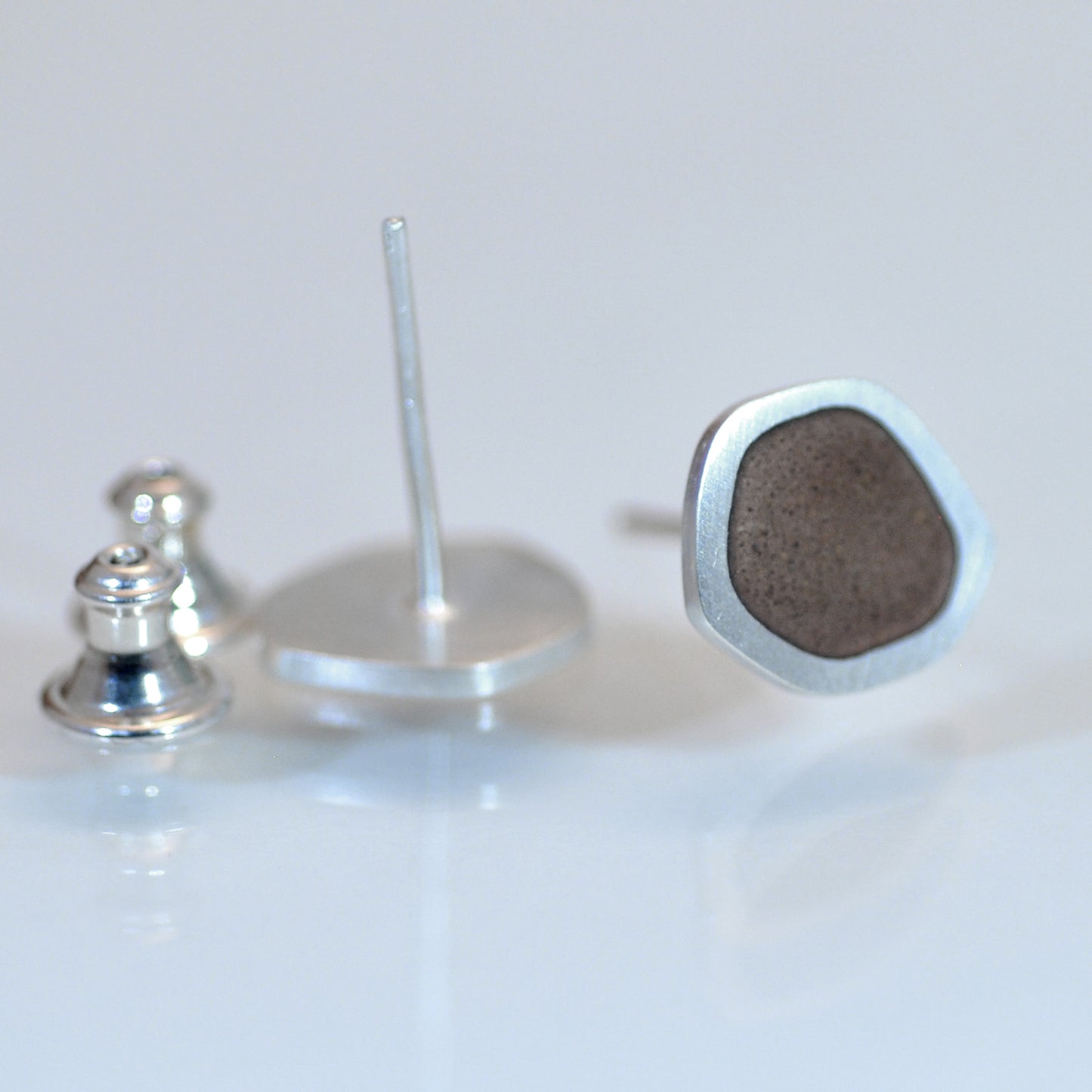 ‘Flat - Boulder’ ear studs. Sterling silver and vitreous enamel, brown