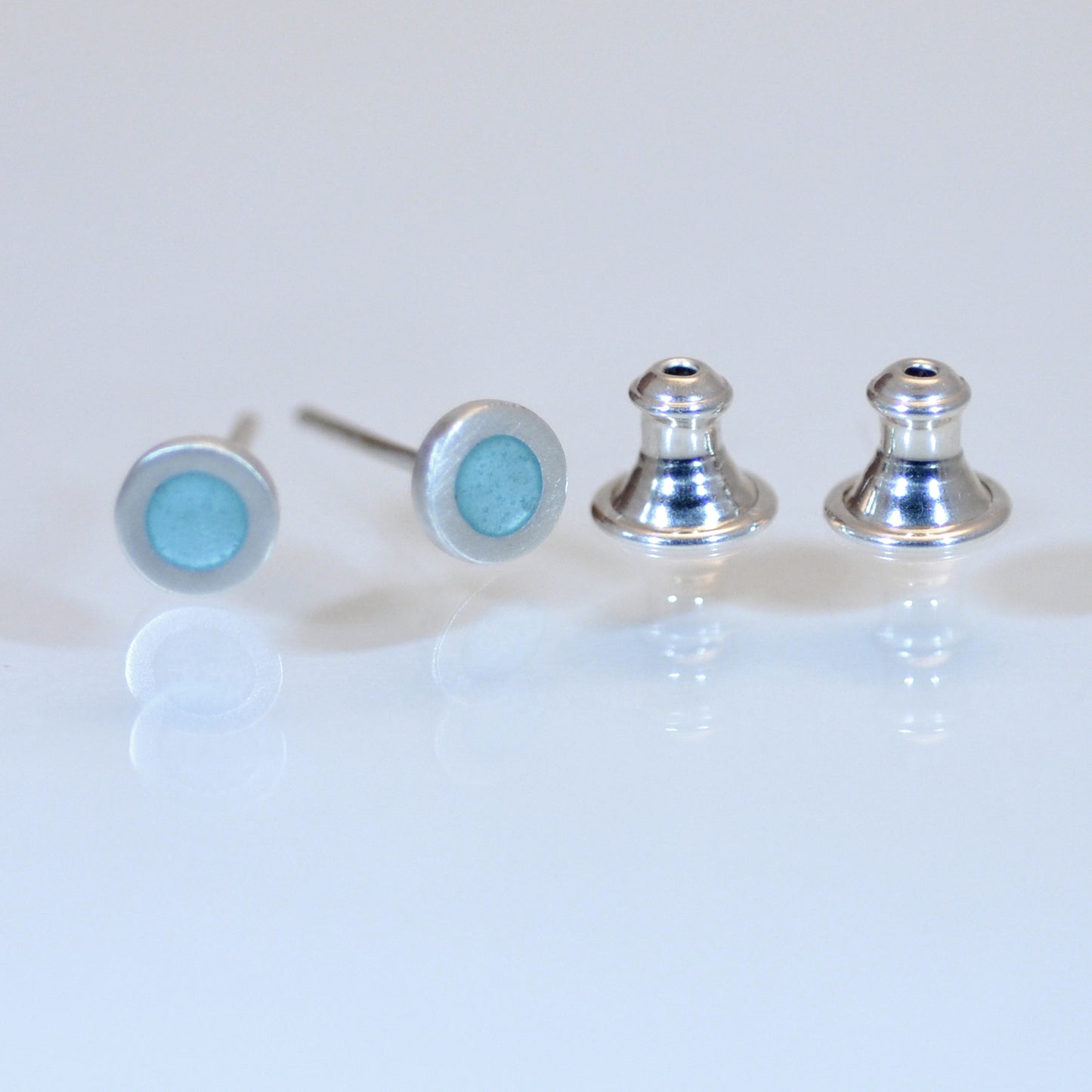 Tiny Round silver and enamel ear studs, this colour light turquoise blue