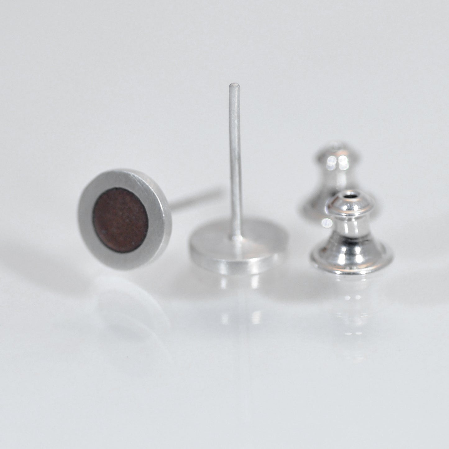 Small round silver flat ear studs, brown