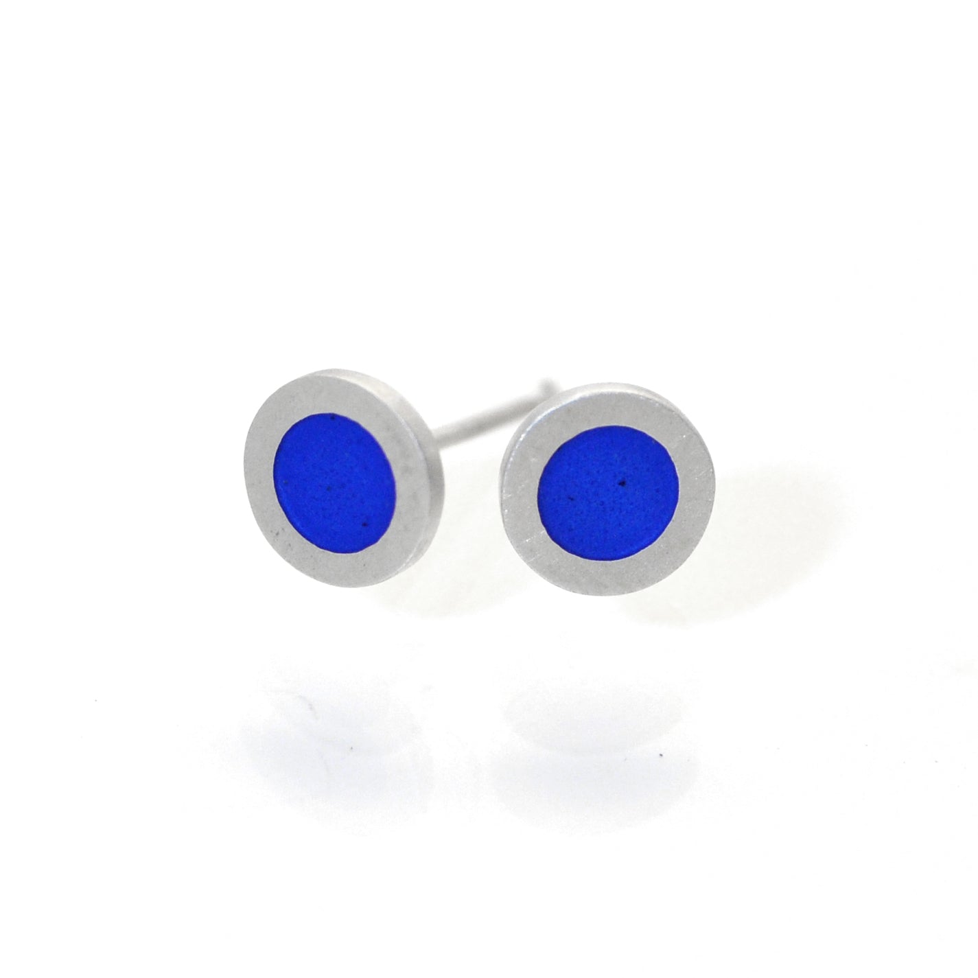 Small flat round ear studs with Mid blue coloured enamel in the centre