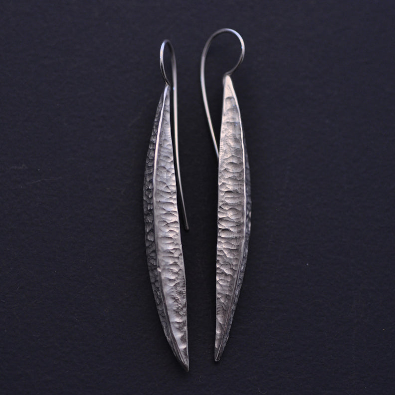 Long silver textured pod earrings
