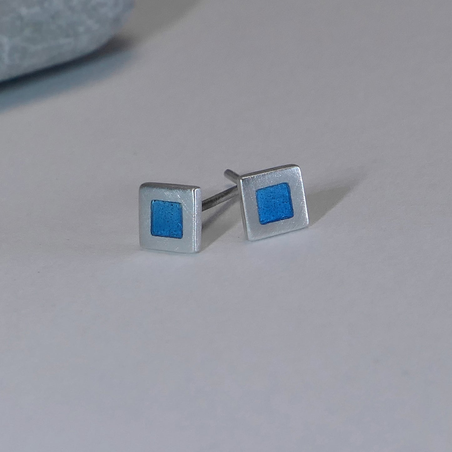 Tiny sterling silver square stud earrings with blue turquoise enamel
