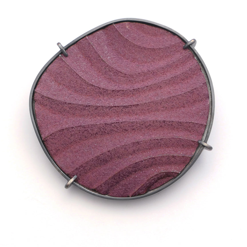 Brooch, finely textured enamelled surface in contoured lines,purple colour with