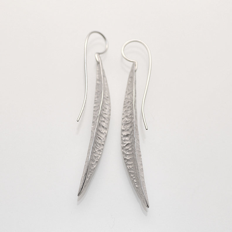 Long silver textured pod earrings