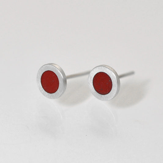 Small flat round ear studs with Red coloured enamel in the centre